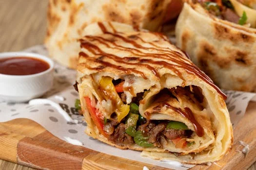 steak burrito with peppers and onions